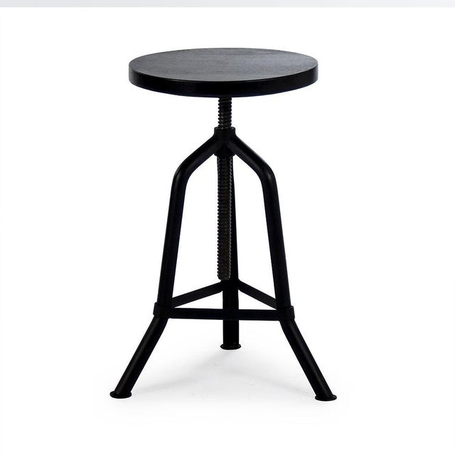 The Evolution Revolving Stool from Zentique is an industrial-rustic adjustable stool with a round dark walnut recycled...