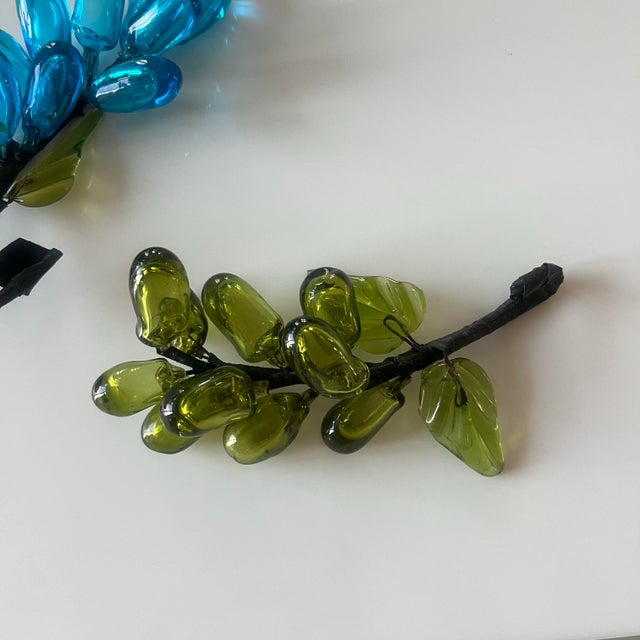 Colorful assortment of blown glass grape clusters: one in turquoise and one in green with nice leaf and vine detail....