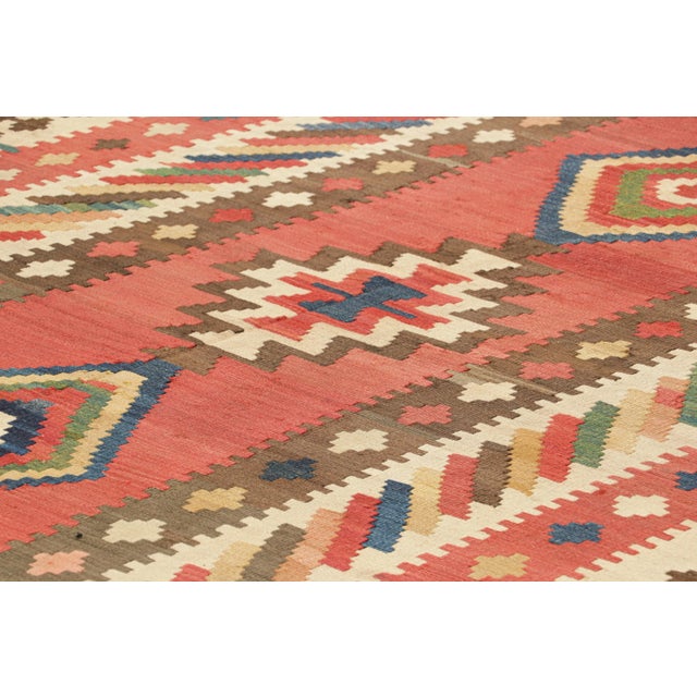 Handwoven in a wool flatweave, originating circa 1950-1960, this 6x15 vintage Turkish gallery runner kilim is an excellent...