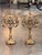 A pair of gilt bronze candelabra, each with a central urn issuing four scrolling arms with gadrooned drip pans and fluted...