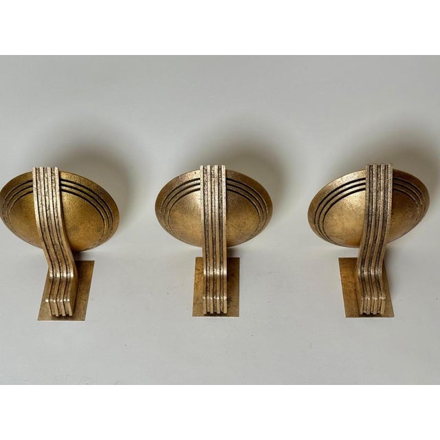 A rare and sculptural wall light by the german artist bernd beisse, model *olympia*, offered here as one of three...