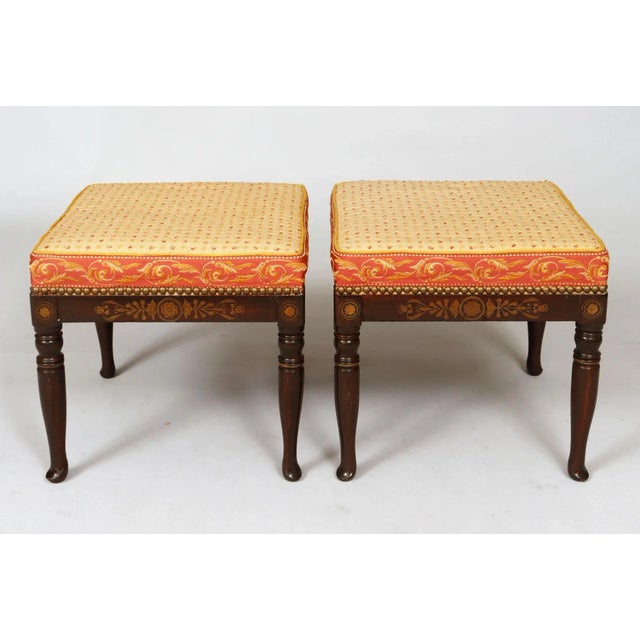 Pair of square faux rosewood stools with gilded designs on the friezes on all sides, raised on ring-turned legs ending in...