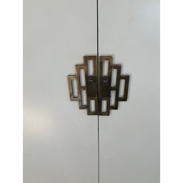 A very attractive cream Asian cabinet. Origin is unknown. Piece was purchased from Dove cote in Westport when it was open...