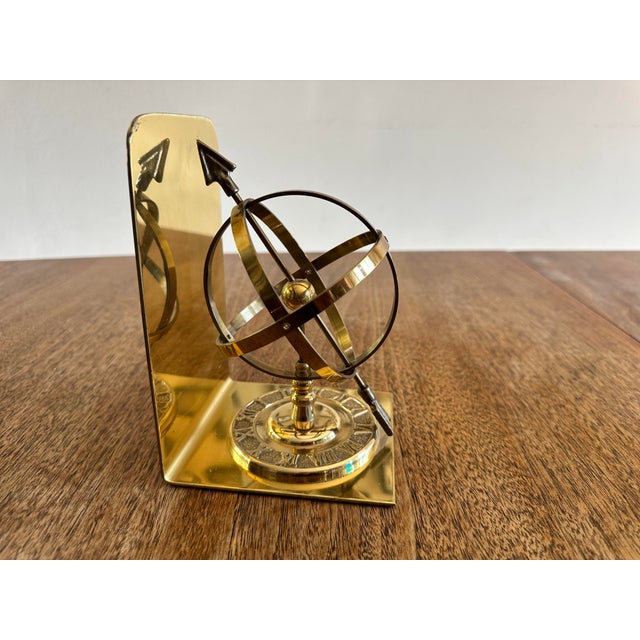 Elegant and timeless solid brass bookend featuring a miniature armillary sphere with arrow and Roman-numeral base. Crafted...