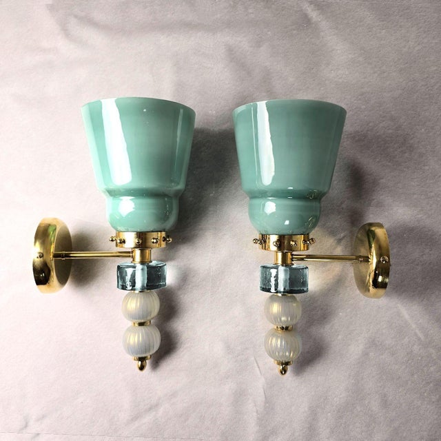 Pair of mid-century modern Murano glass wall sconces, Italy circa 1990s. The pair of Italian sconces is made of acqua...