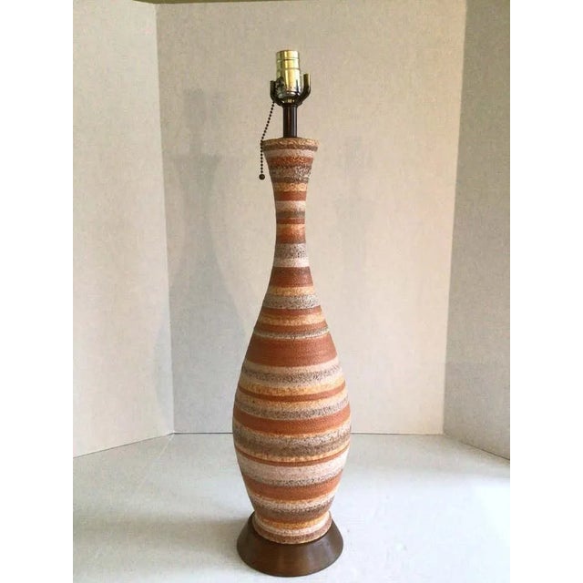 1960s Mid Century Glazed Ceramic Table Lamp With Wood Base Salmon/peach, grey, brown, cream/yellow stripes Textured glaze...