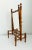 A stately faux bamboo tabletop or vanity mirror, crafted during the late 19th-century Victorian era. Features a finely...