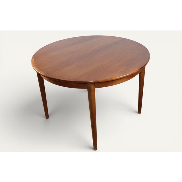 Beautiful Danish teak dining table from the 1960s. Its round top extends with two leaves, creating a comfortable oval...