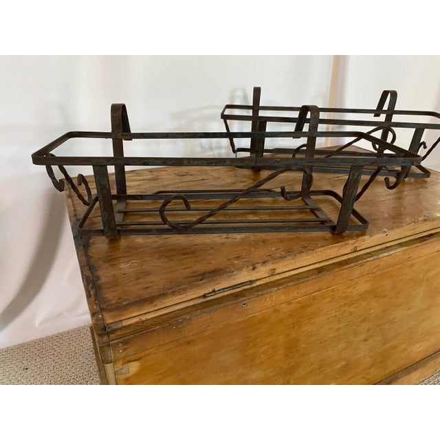 A pair of rail hung plant holders for the garden. Heavy gauge iron painted black.