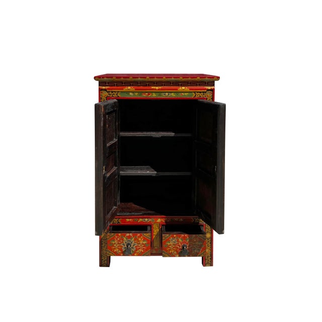 This cabinet / table is painted with colorful mix (orange red rim and yellow base and orange doors) Tibetan style flower...