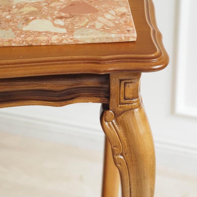 A side table in the louis xv style, crafted in the 20th century as a reproduction of historical models. The curved legs,...