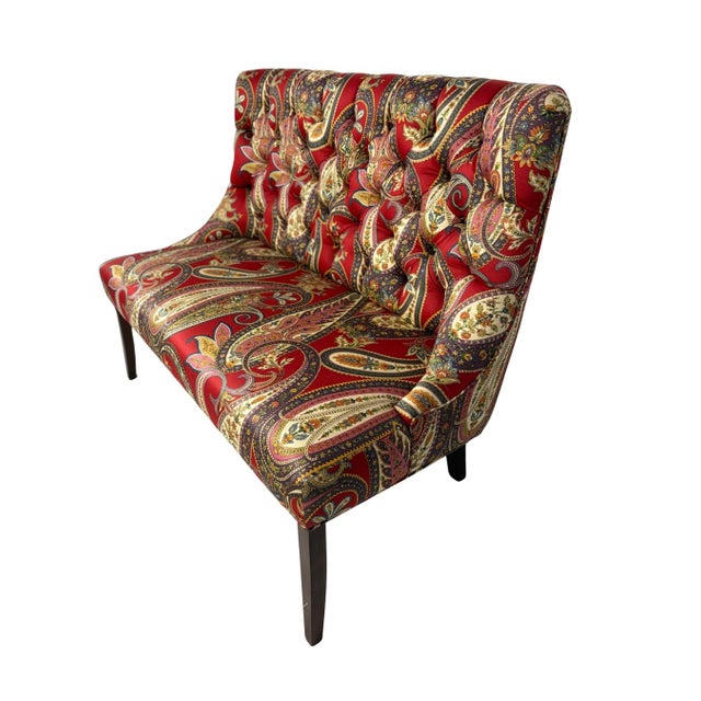 Tufted upholstered bench with back in a bold red paisley fabric. Features deep button tufting, a comfortable sloped back,...