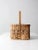 A vintage splint weave basket with a hand-crafted carrying form and a natural, time-softened tone. The interior features a...