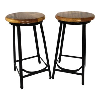 Pair of Restored 1950s Black Metal Farmhouse Shop Stools With Foot Rests and Pine Seats For Sale