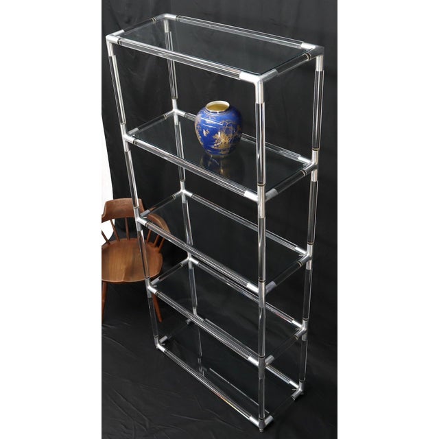 Mid-Century Modern Lucite and glass tall narrow shelving unit étagère.