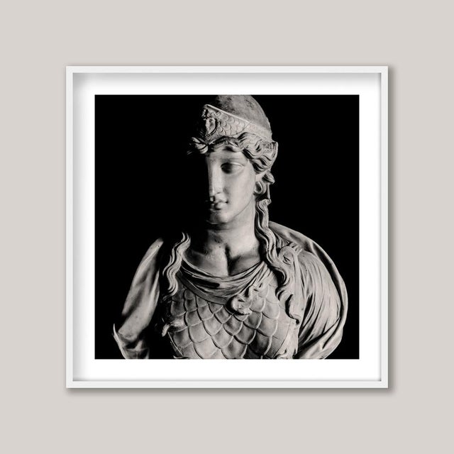 A classical, poignant sculpture of a woman clad in armour. Her expression carries both resolve and sorrow, as if bearing...