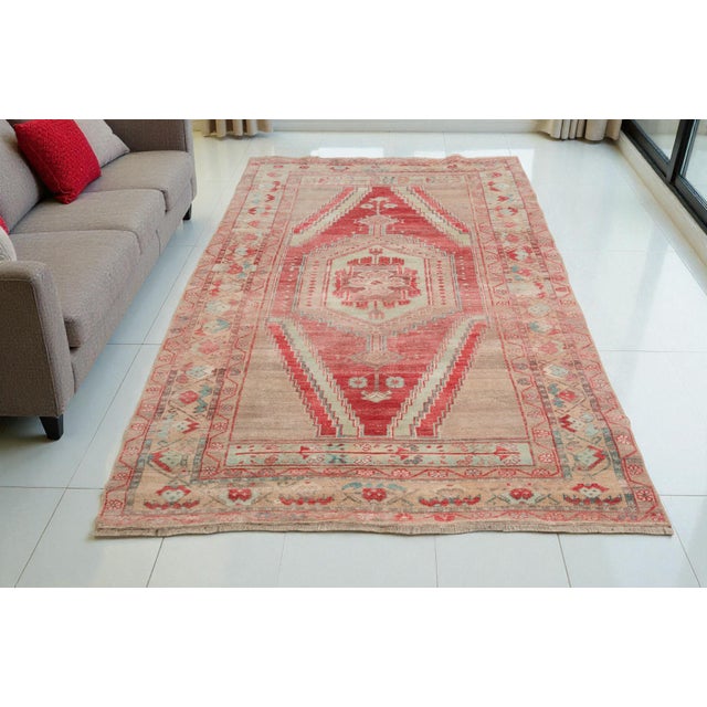 This is a vintage Turkish Oushak rug from the 1960s. The piece was hand-knotted.