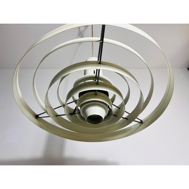 This suspension lamp, designed by Fog & Mørup in Denmark during the 1960s, features a striking arrangement of cylindrical...