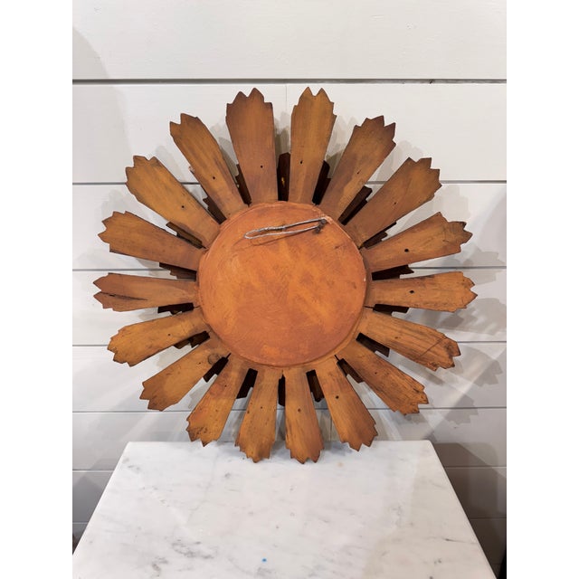 This sunburst mirror comes to your home from mid-century Spain. Its flat mirror has a few blemishes from age, but still...