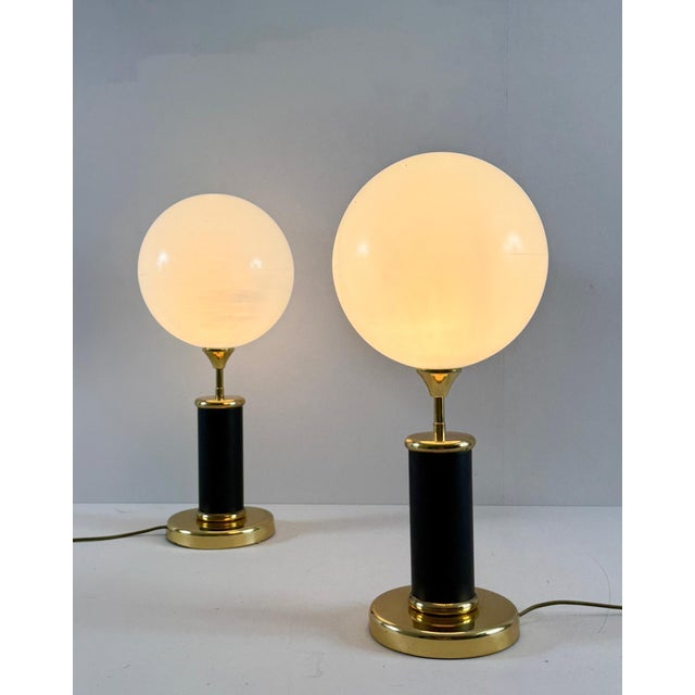 Set of 2 Art Deco style table lamps, 1980s, constructed of brass and resin, with acrylic glass shades, manufacturer's...
