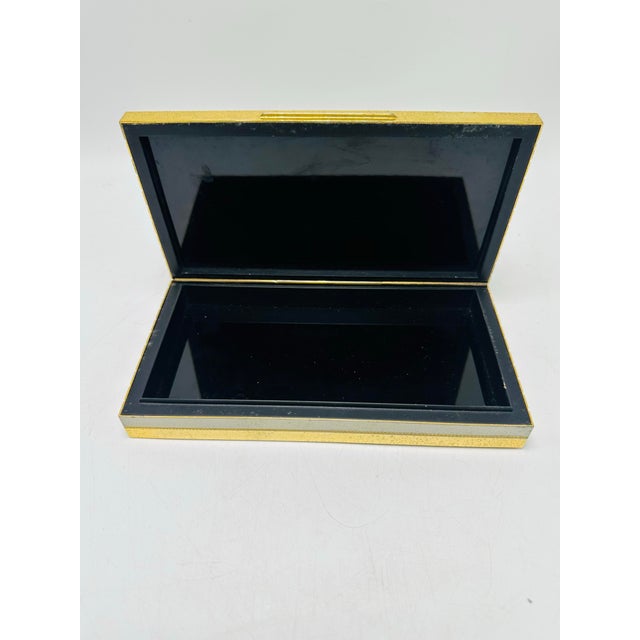 This is a vintage Italian gold-tone metal trinket or jewelry box with a sleek rectangular shape and striped ridged design...