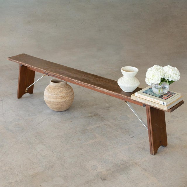 Great long wood bench from France with long plank seat. Wood legs with arched cutout and metal supports on underside....