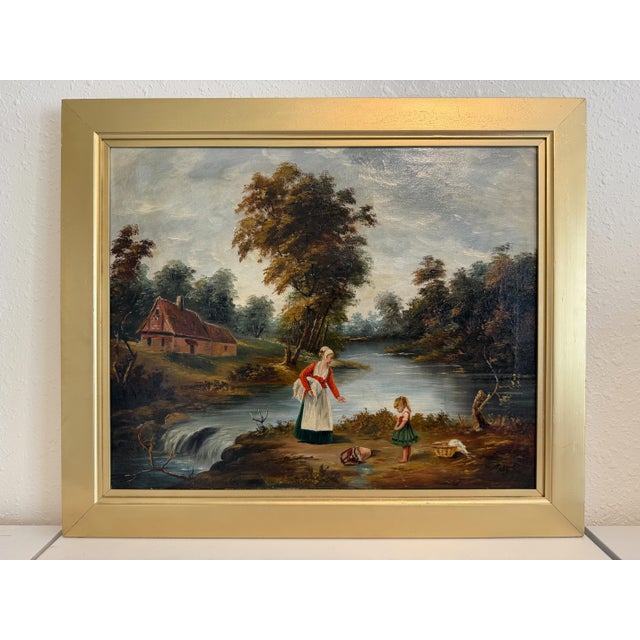 This charming antique oil on canvas painting depicts a peaceful rural scene featuring a mother and child beside a quiet...