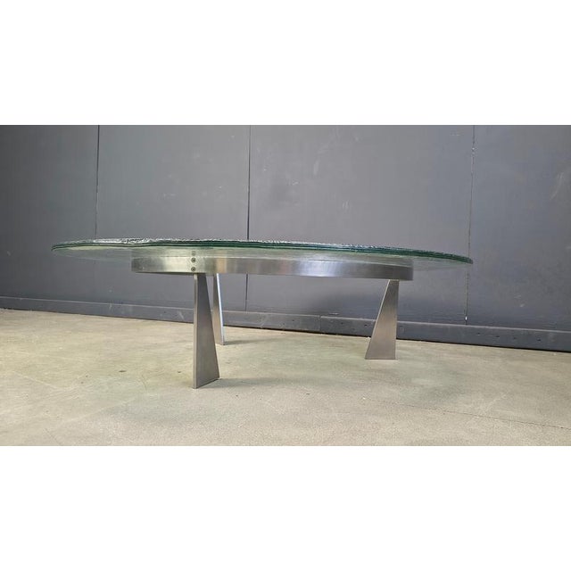 Beautiful coffee table with a steel tripod base and a gorgeous glass top by Jos Van Beek for Metaform, Netherlands. 1980s...