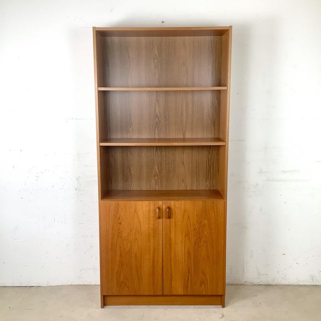 Bring timeless Scandinavian style and everyday functionality into your home with this handsome teak bookcase cabinet...