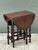 This charming vintage gate-leg side table beautifully captures the timeless appeal of English Jacobean design. Crafted...