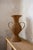 Decorative amphora entirely crafted from woven wicker, featuring a rounded central body, flared neck and two large side...