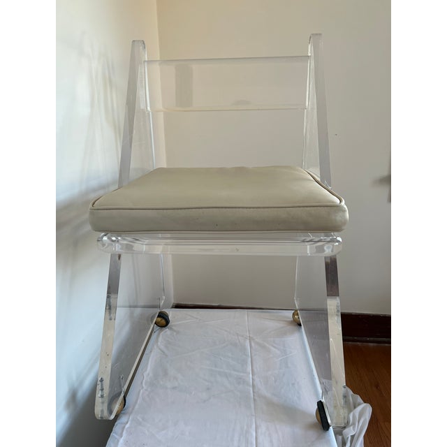 For sale is a solid, heavy duty mid century thick lucite desk chair on wheels. It is all original including, the chair,...