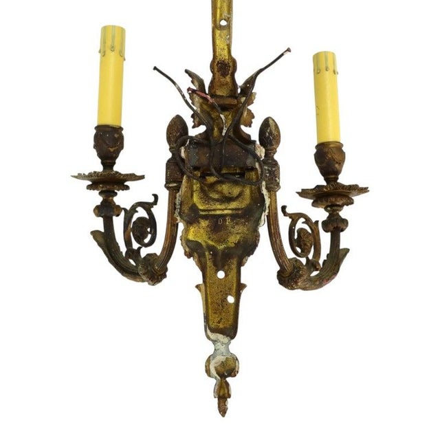 This is a pair of antique gilt bronze two-light wall sconces, crafted in the Louis XIV style, dating to approximately...