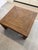 Vintage woven rattan square coffee table featuring a striking geometric paneled top and substantial architectural form....