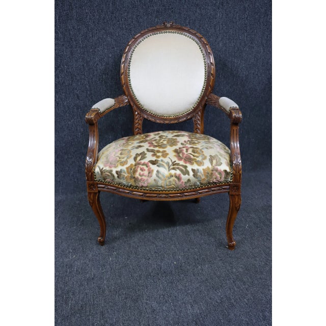 Louis XV Style Walnut Carved Armchair, oval ribbon carved back with cream upholstery, floral upholstered seat