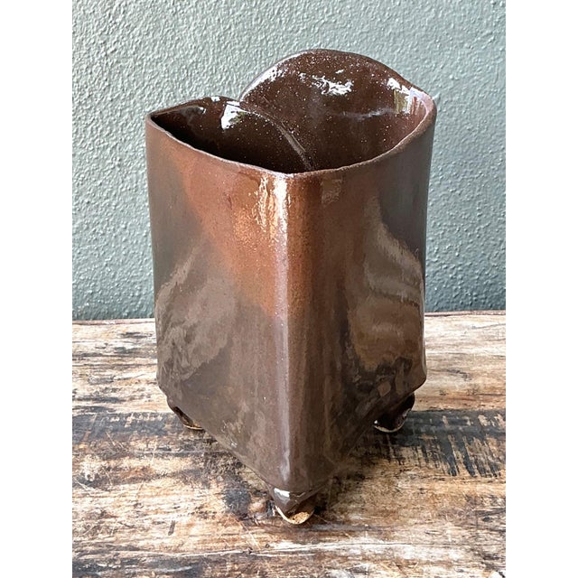 This vintage handcrafted pottery vase is a distinctive expression of artisanal ceramic craftsmanship, defined by its...