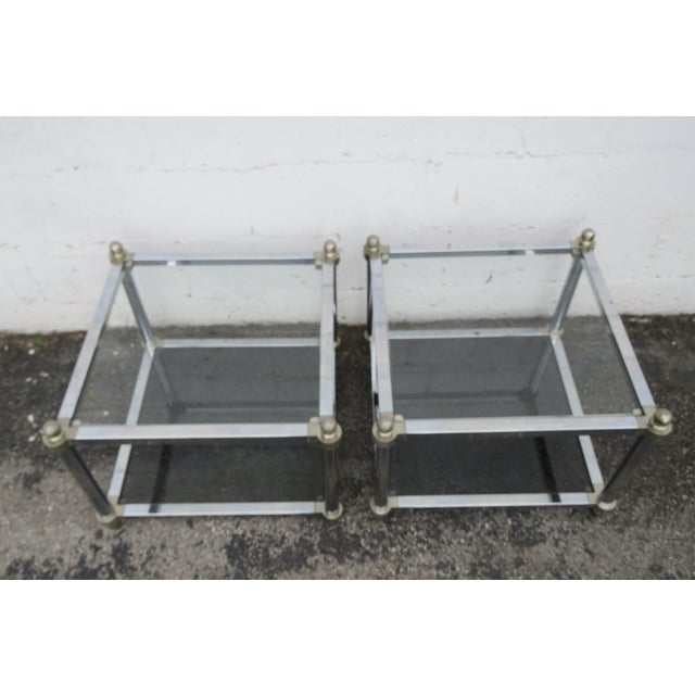 This beautiful Pair of Side Tables are made out of metal, and glass. The Tables have Hollywood Regency design, two tiers,...