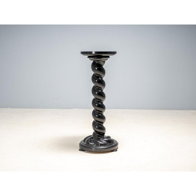 This elegant flower pedestal stand reflects Neo-Baroque influences typical of Central European decorative furniture from...