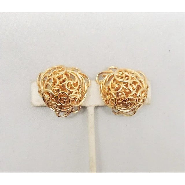 This is part of Chairish’s Costume Jewelry assortment. 1960s goldtone domed ferns clip back earrings. Marked "Napier."...