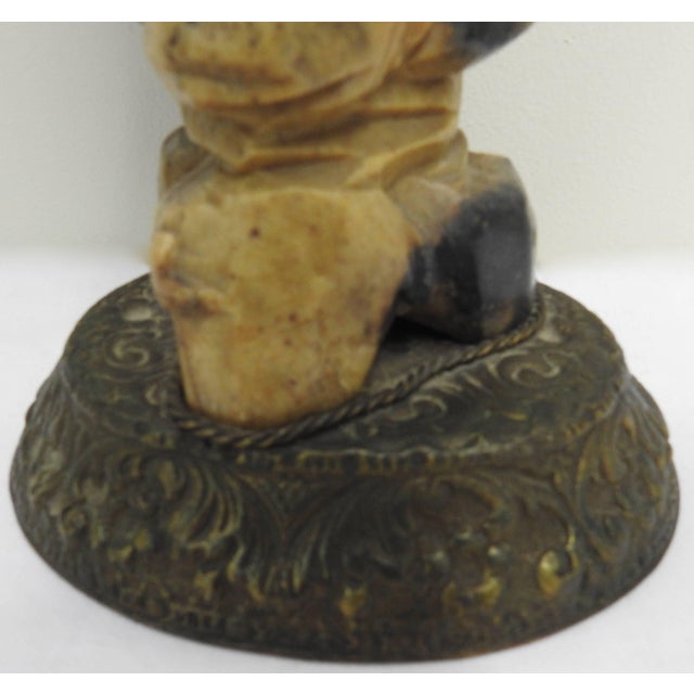 This hand-carved soapstone figure of a bearded man holding a fish in one hand and a staff in the other will make you...