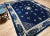 A graceful 19th century Chinese Art Deco rug in a near-square room-size format, featuring a deep navy blue field of...