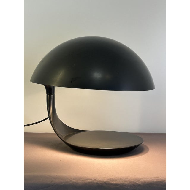 Direct-light table lamp composed of two molded resin bodies. The lower body rotates on the underlying steel base and is...