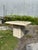 Beautiful Italian Travertine Side Table. Polished at tabletop with a double beveled edge. Remainder of stone is a rough...