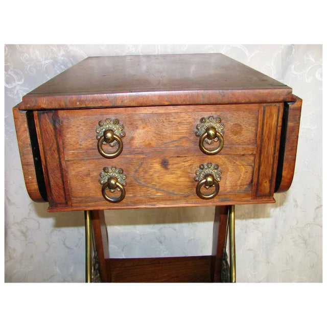A superb English Regency period rosewood sewing or work table, circa 1820. The table features dramatic rosewood, inlaid...
