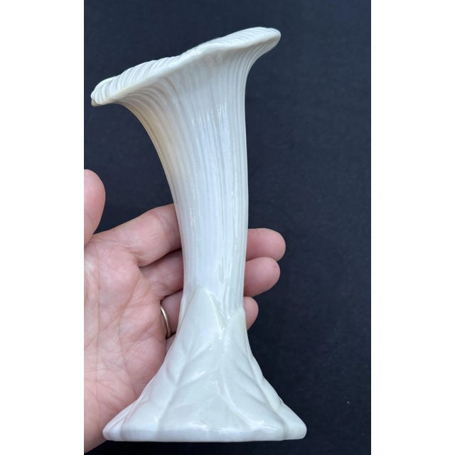 This vintage Belleek vase was crafted in Ireland between 1965 and 1980, and bears the 3st Green Mark (6th mark) on the...