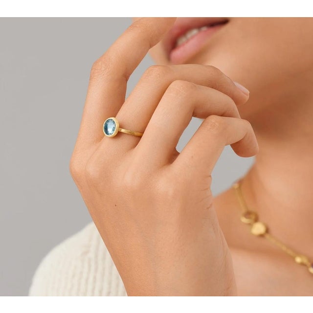 This gorgeous ring by Italian designer Marco Bicego and from their Jaipur Collection, contains a round rose cut blue topaz...