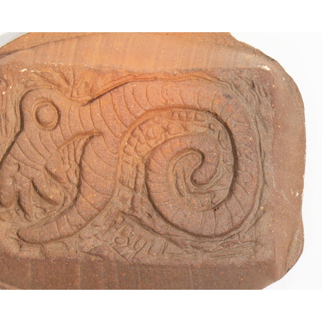 A studio pottery tile made by the American artist Mark Bulwinkle (born 1946). This tile depicts an impressed image of...