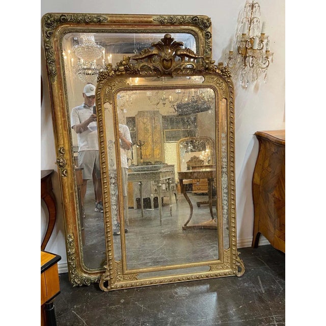 Elegant large 19th century French Louis XVI style giltwood mirror. Beautiful intricate carvings including an elaborate...