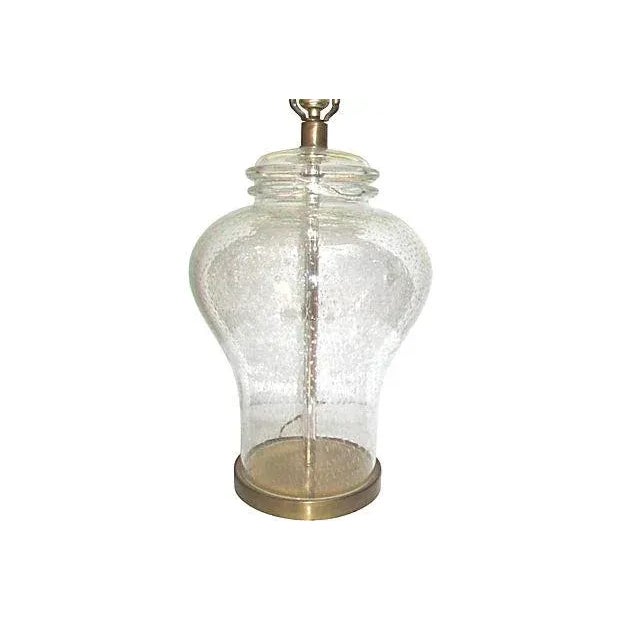 A Mid-Century era Murano clear glass table lamp with controlled bubbles in the glass in a ginger jar form. This vintage...