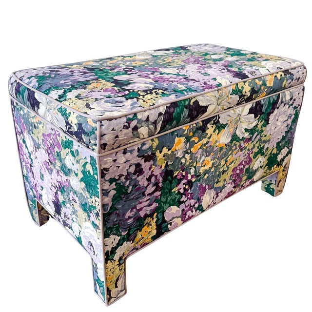 A striking pair of bench ottomans, custom-upholstered in a vibrant, Impressionist-inspired floral print and featuring a...